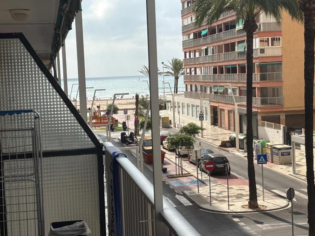 a balcony with a view of a street and the ocean at Brisa Marina in Cullera