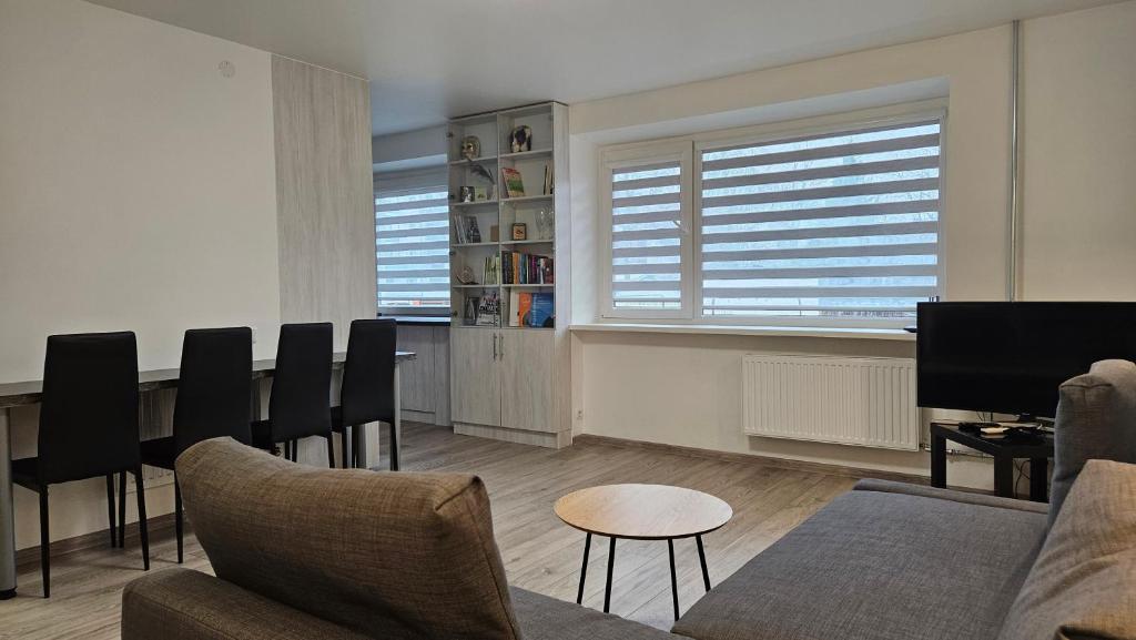 a living room with a couch and a table at Draugyste Apartment in Šiauliai
