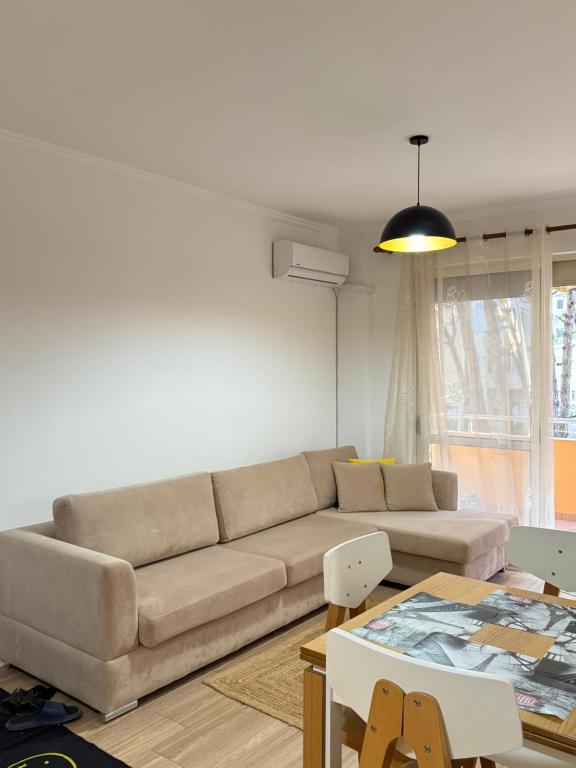 a living room with a couch and a table at Coastal Comfort Apartament in Golem