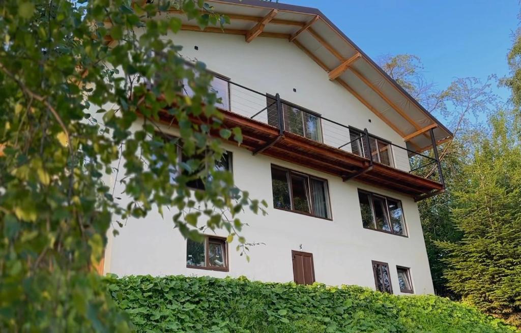 a large white building with a balcony on it at Vista Krasiya in Vyshka