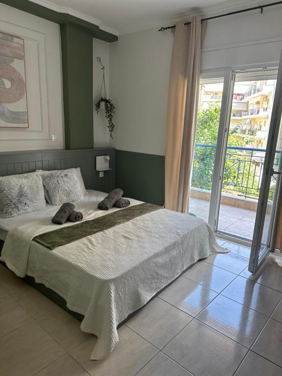 a bedroom with a large bed and a large window at Bloem in Komotini