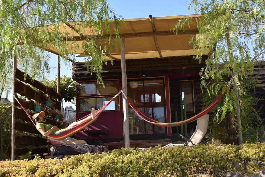 a couple of hammocks in front of a house at Santuario Cosmico Mamalluca in Vicuña