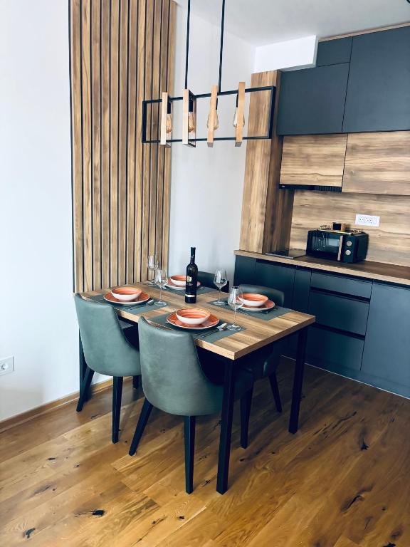 a dining room with a table and blue chairs at Davos in Zlatibor