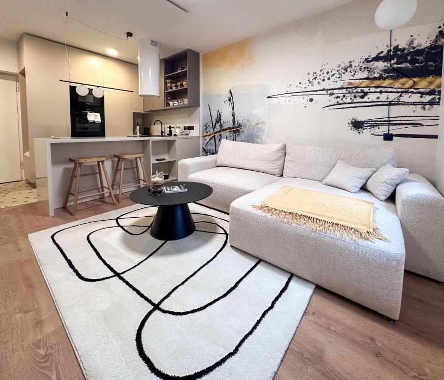 a living room with a couch and a table at Mavrin Home Zagreb, free parking, 3,8km from Old Town, Breakfast in Zagreb