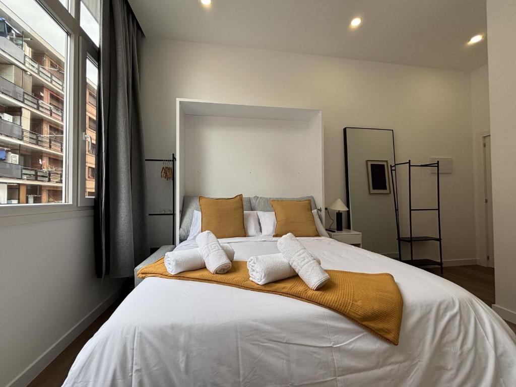 a bedroom with a large white bed with two pillows at Gabika Apartment 4 in Bilbao