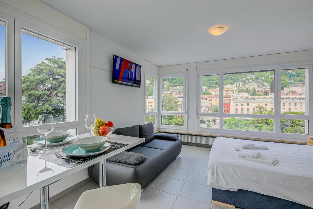 a living room with a couch and a table at Casa Cupido- Happy Rentals in Locarno