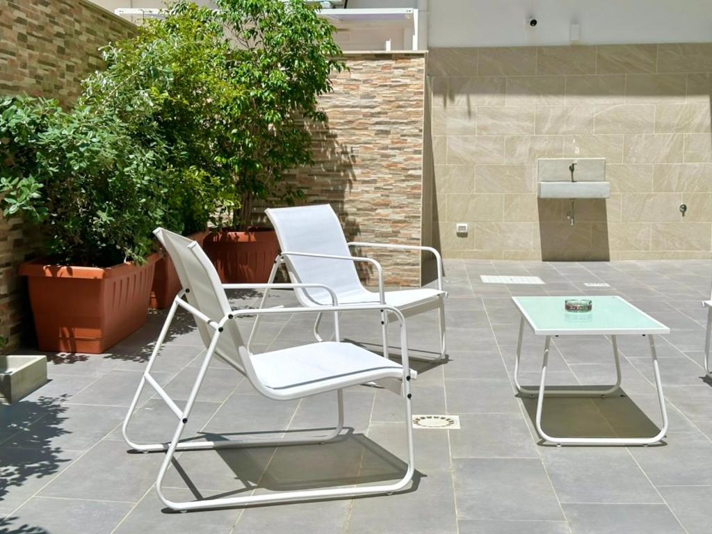 two chairs and a table on a patio at Casa Genzino in Molfetta