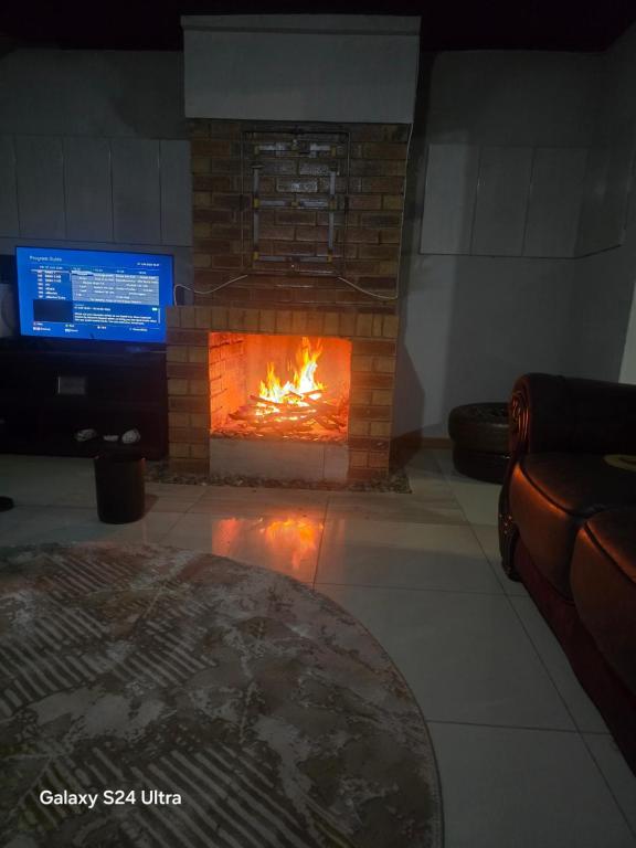 Una chimenea en una sala de estar con chimenea. en Homestay, 