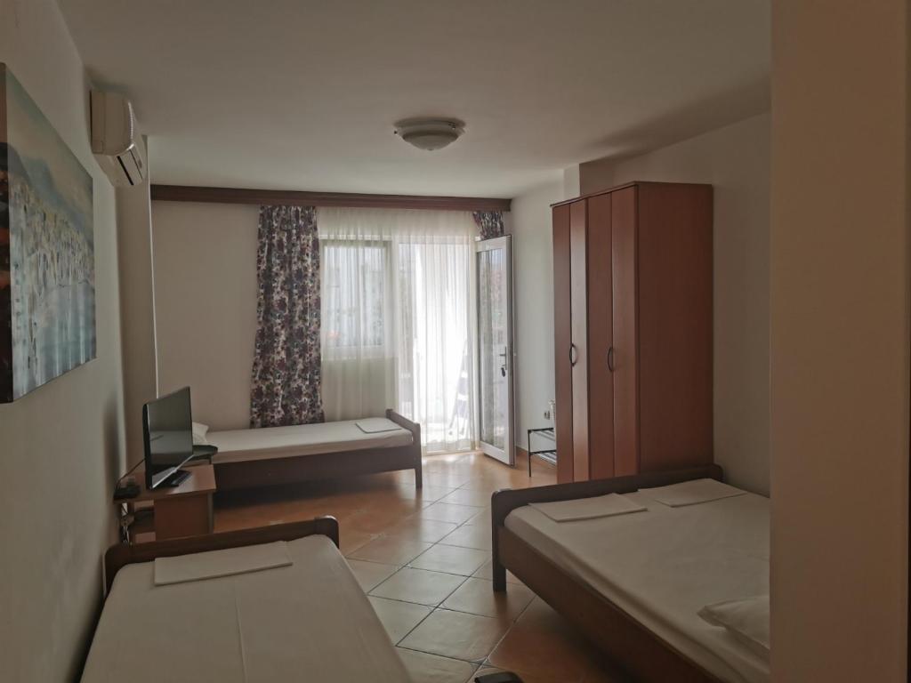 a small room with two beds and a window at Apartment Aleksic Becici in Bečići