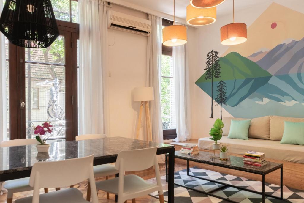 a living room with a table and chairs and a couch at Fliphaus - Cerviño 3 Bd Palermo Chico in Buenos Aires