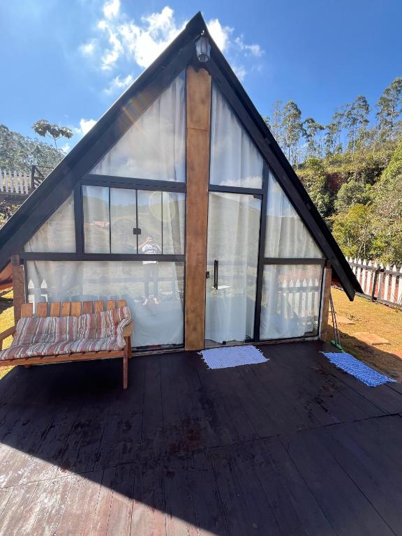 a pavilion with a bench on a wooden deck at CHALÉS VILA RICA - Bar do Ricardo in Ouro Preto