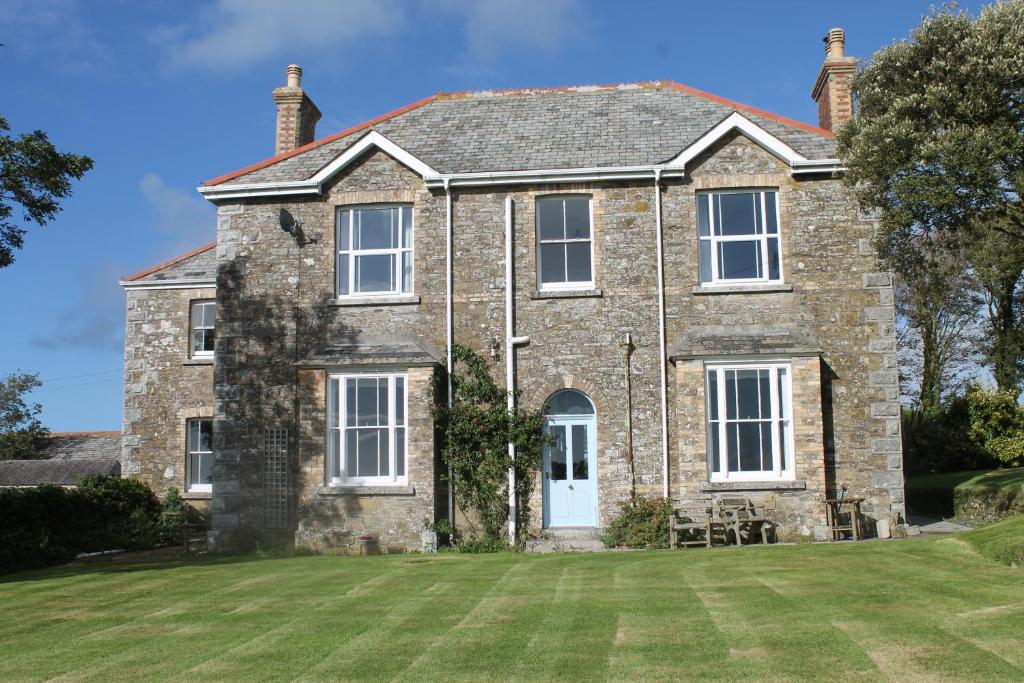 a large brick house with a large yard at Trevanger Farm Bed and Breakfast in Wadebridge