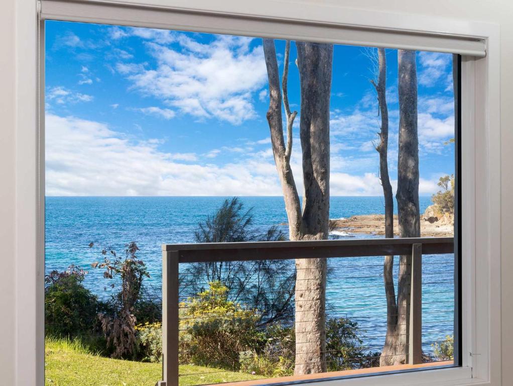 a window with a view of the ocean at Oceanfront Beauty in Lilli Pilli in Surf Beach