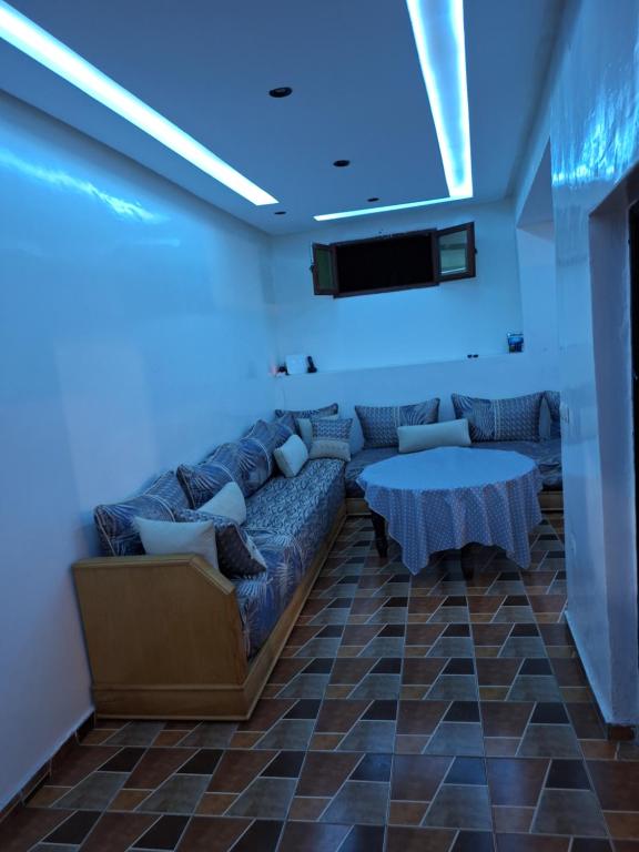 a living room with a couch and a table at La Pause Dar Bouazza in Tamaris