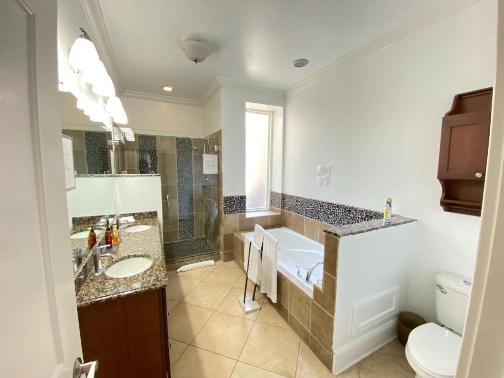 a bathroom with two sinks and a shower and a toilet at Classy Victorian Brownstone Subway Shopping in Washington
