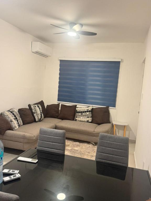 a living room with a couch and a table at DEPARTAMENTO ARRECIFES PLAYA MIRAMAr in Madero