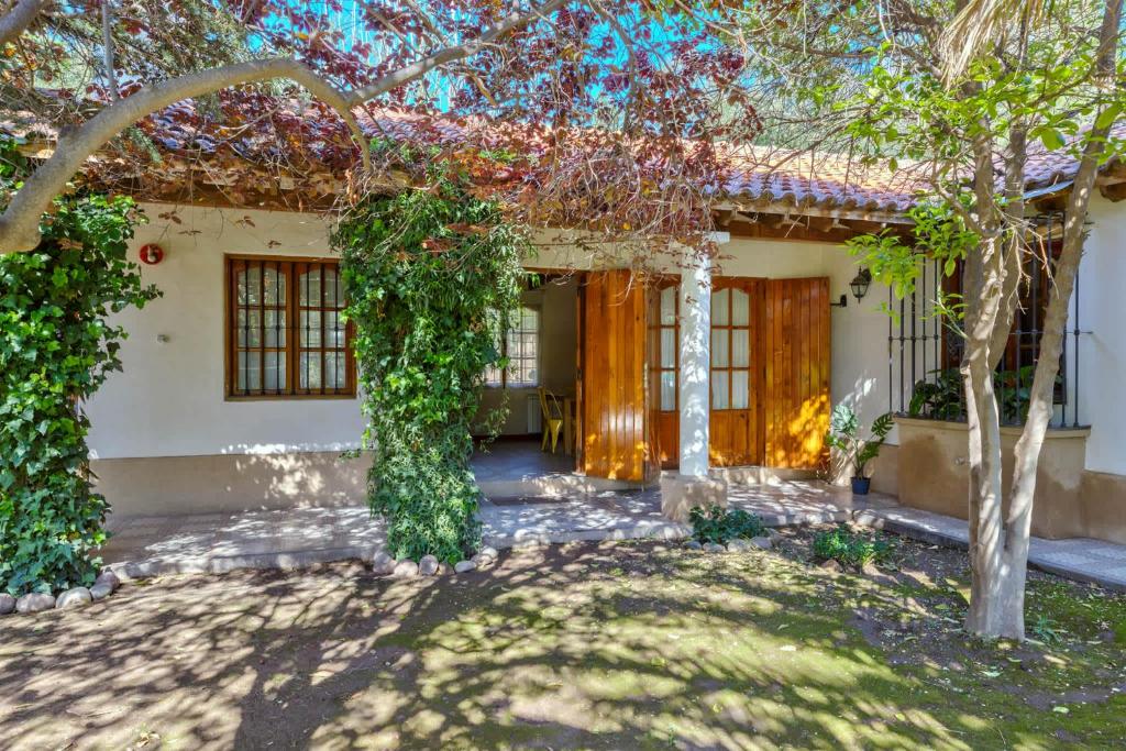 a house with ivy on the side of it at Fliphaus Alzaga 5100 - 4 Bd House Pool BBQ Daily Housekeeping! in Mendoza