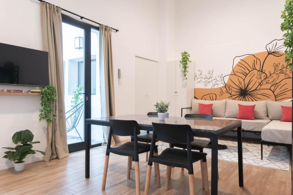 a living room with a table and chairs and a couch at Fliphaus Libertador 6300 - RiverPlate Stadium A in Buenos Aires