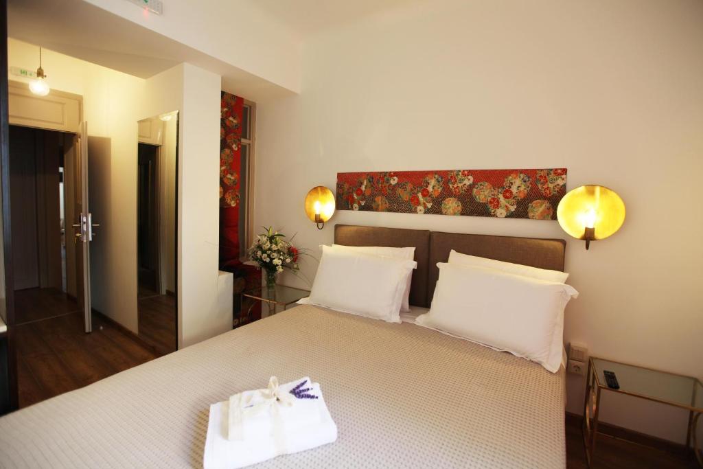 a bedroom with a bed with two white towels on it at Messini Pension in Nafplio