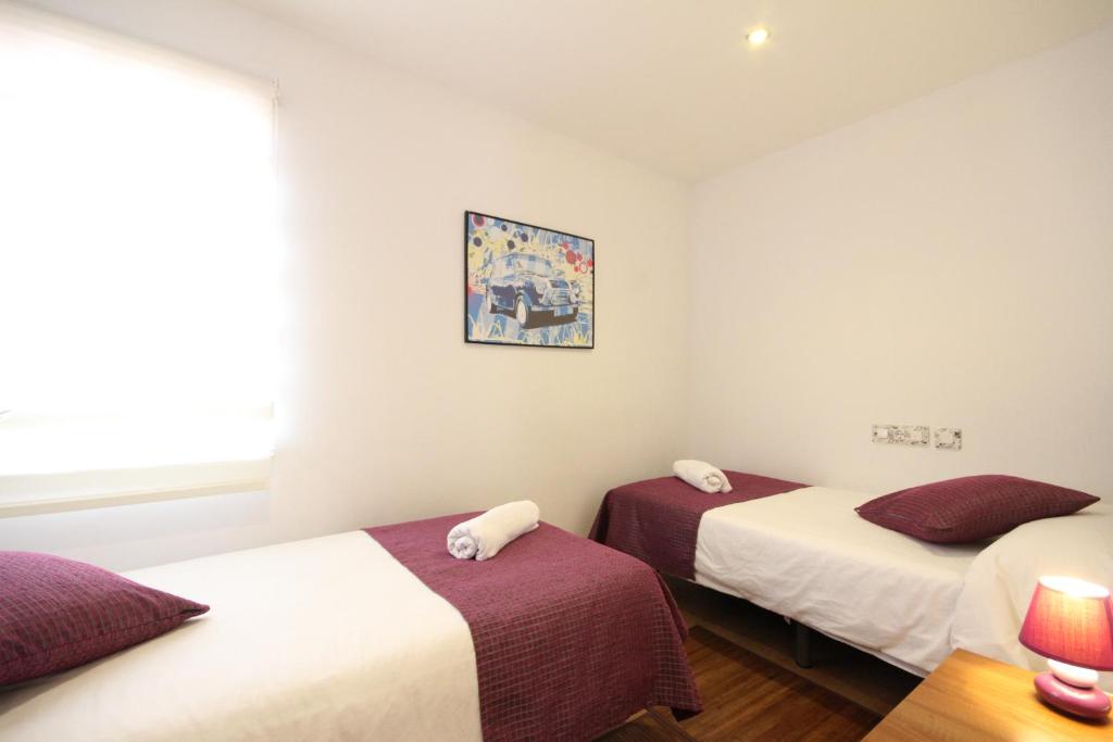 Postel nebo postele na pokoji v ubytování Apartamentos Tito San Agustin