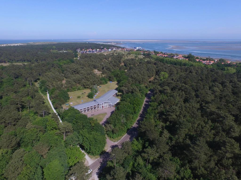 an aerial view of a house in the forest at Hotel DoniaState in Oost-Vlieland