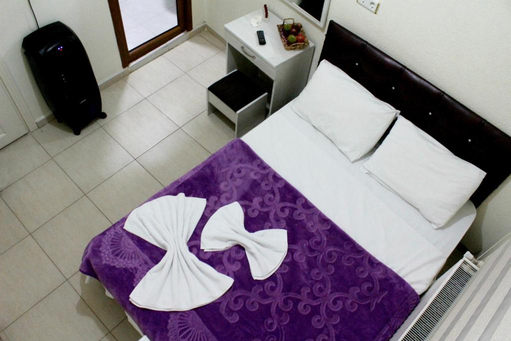 a bedroom with a bed with a purple blanket at Hotel Baris in Istanbul