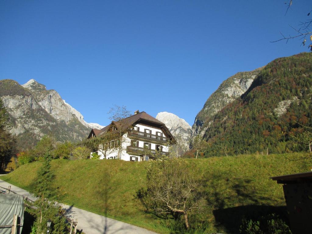 a house on a hill with mountains in the background at Apartments Mija in Krotica
