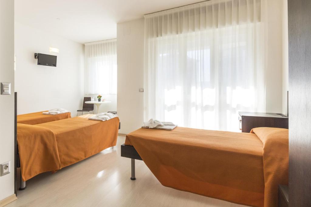 Postel nebo postele na pokoji v ubytování Hotel Sharing