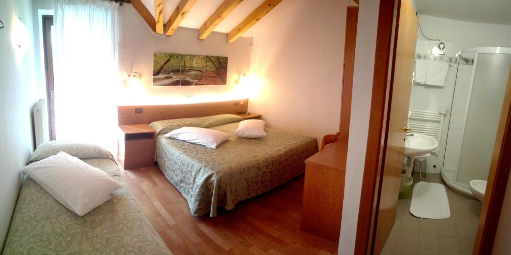 Postel nebo postele na pokoji v ubytování Hotel Denny