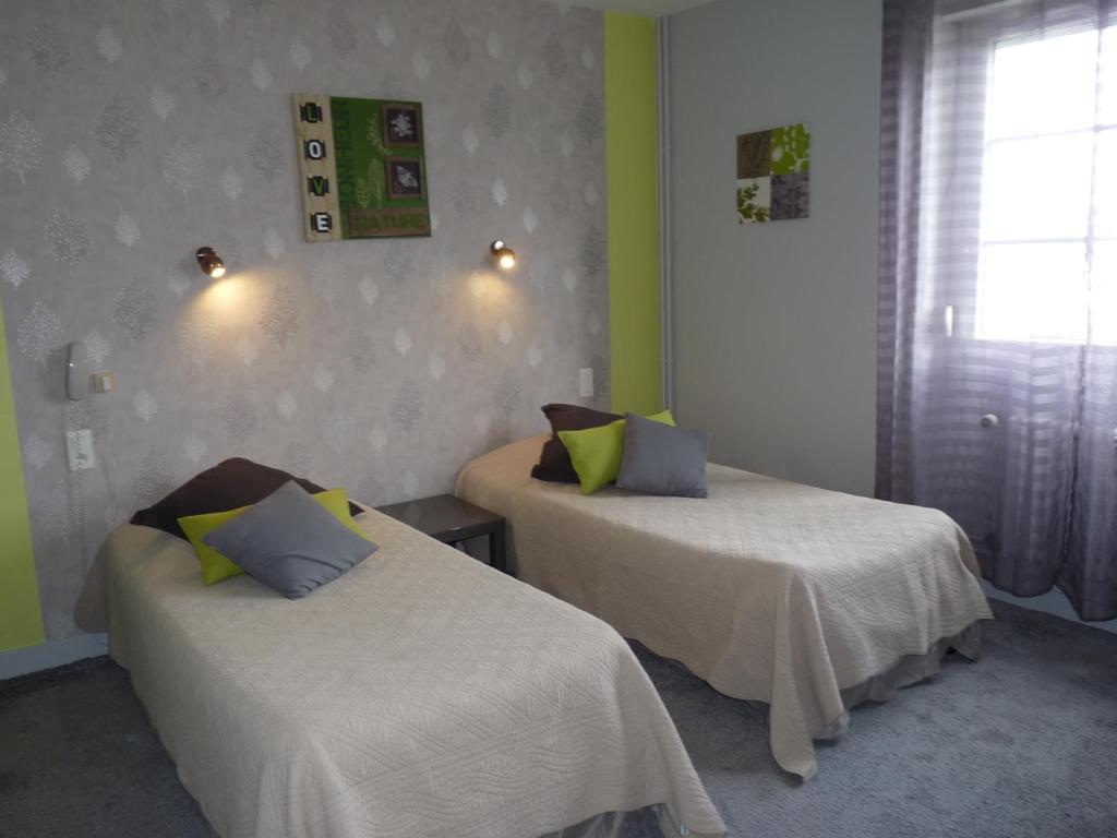 Postel nebo postele na pokoji v ubytování Hôtel Patton