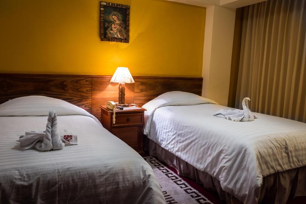 Postel nebo postele na pokoji v ubytování Kaaro Hotel El Buho
