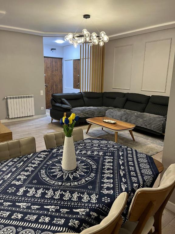 a living room with a table with a vase on it at BST Batumi Leo in Angisa
