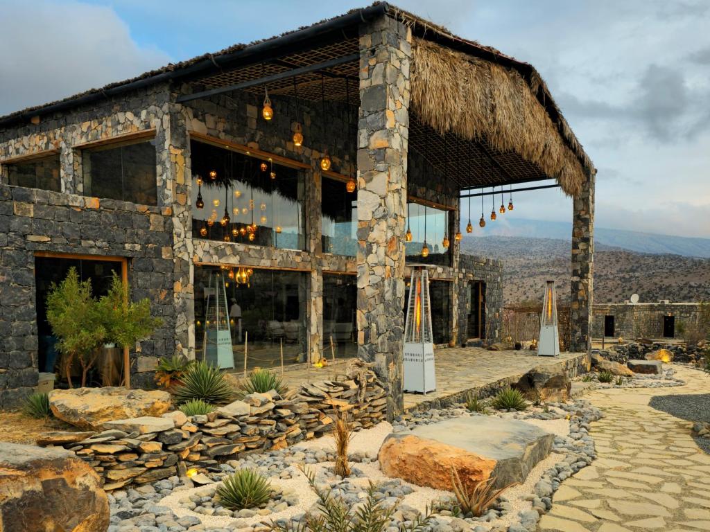 a stone building with a thatched roof at Sama Heights Resort in Dār Sawdāʼ