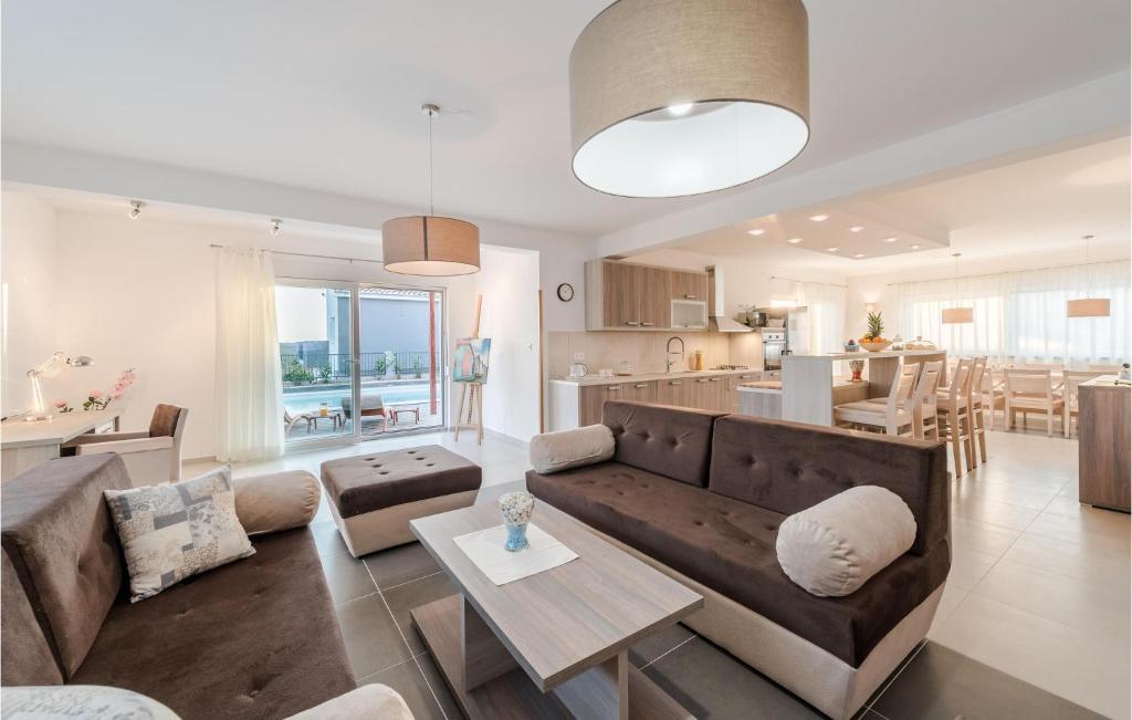 a living room with a couch and a table and a kitchen at Gorgeous Home In Debeljak With Wifi in Debeljak