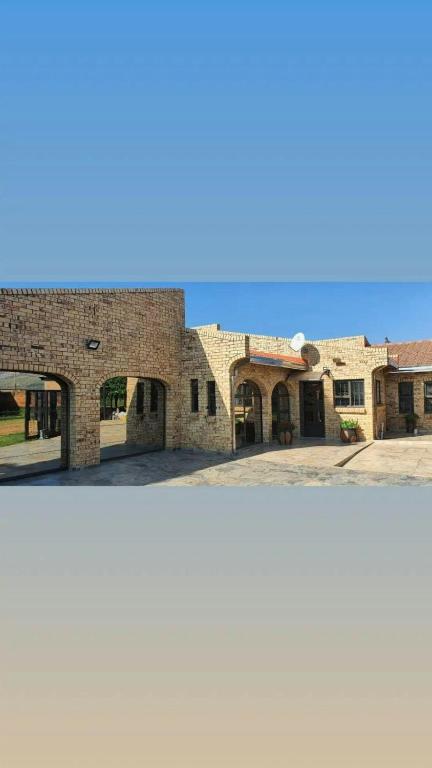 two pictures of a brick building at Relaxing Holiday Home in Phuthaditjhaba
