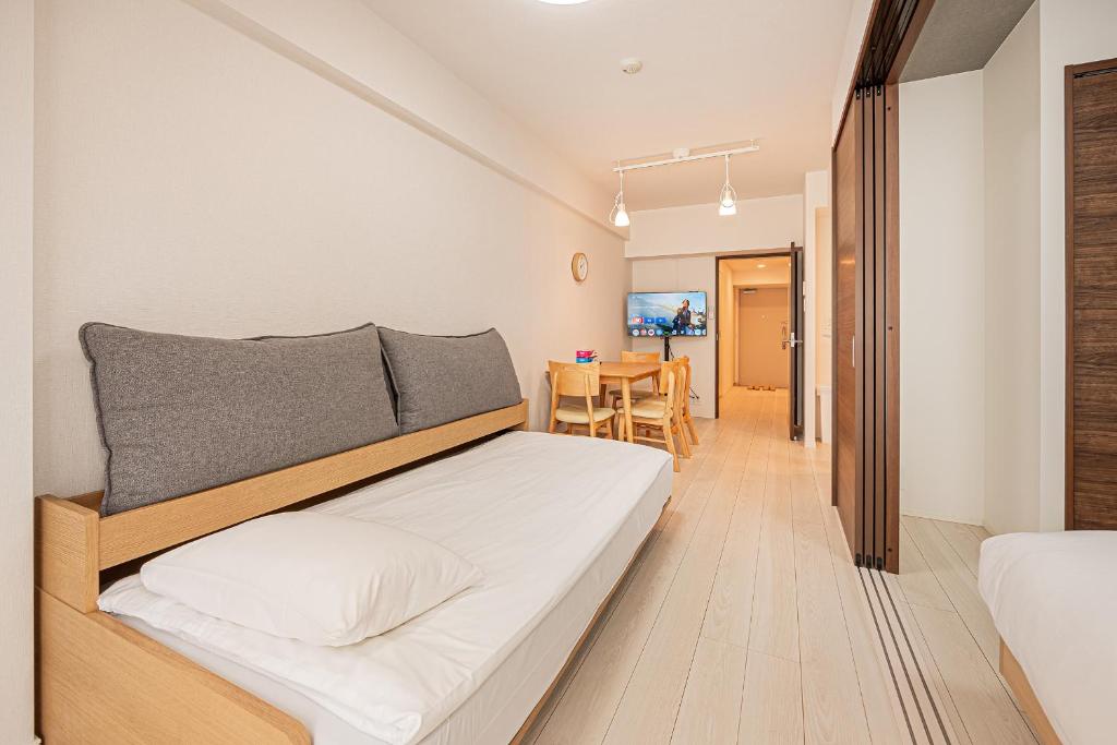 a bedroom with a bed and a dining room at Japan House 御徒町 in Tokyo