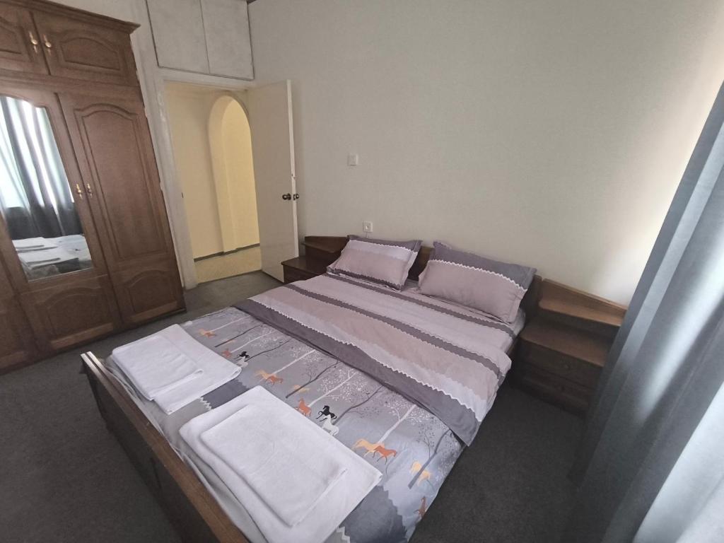 a bedroom with a large bed in a room at Brazeri 2-6-9 in Toshkent-Passajir Bekati