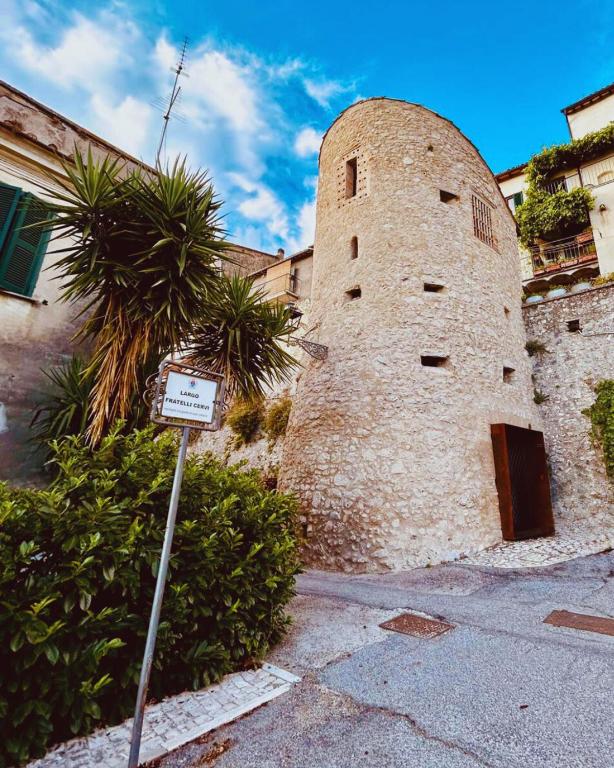 a large brick building with a sign in front of it at Il Rivellino - Tamerò Estates in Casperia