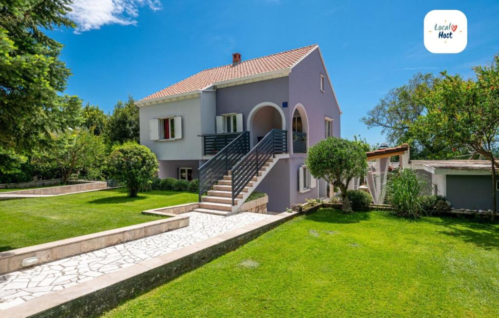 a house with a green lawn in front of it at House Arkulin by Villas Guide in Gruda