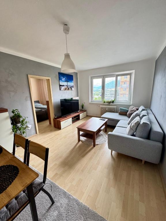 a living room with a couch and a table at Apartmán Športovcov in Dolný Kubín