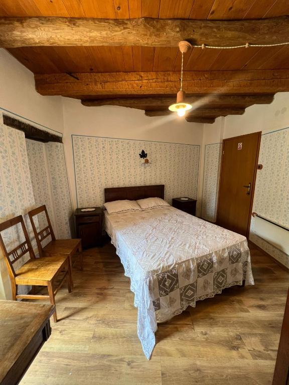 a bedroom with a bed and a wooden ceiling at Rooms Poli Luce - Room Pepa in Gračišće