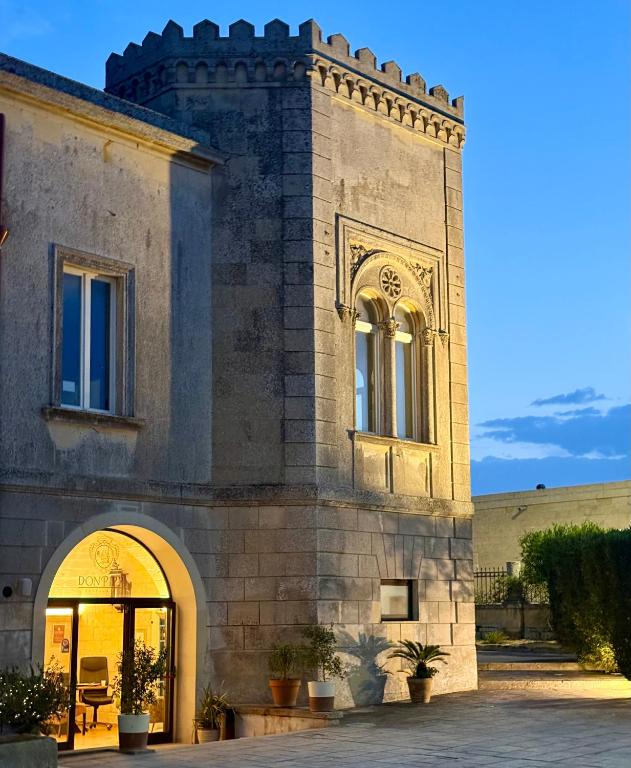 a building with an archway in front of it at Villa Papaleo B&B in Bagnolo del Salento