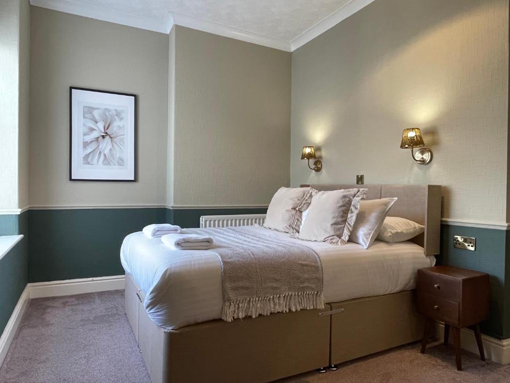a bedroom with a large bed in a room at Wedgwood Hotel, North Shore Room in Llandudno