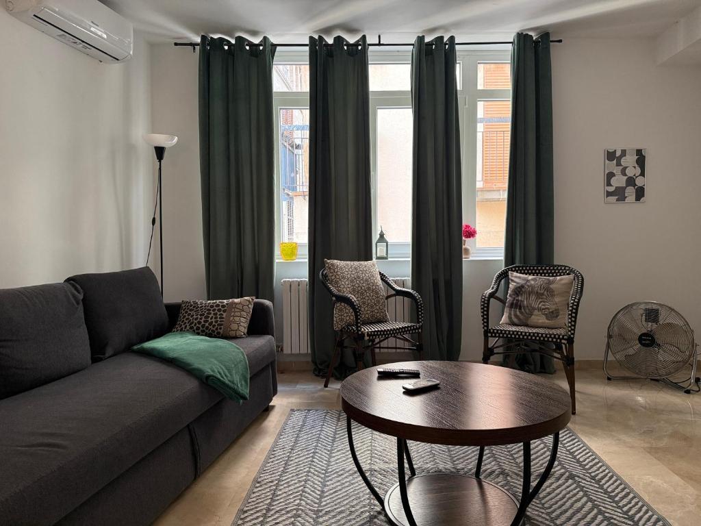 a living room with a couch and a table at 18 Torres Santa Cruz in Zaragoza