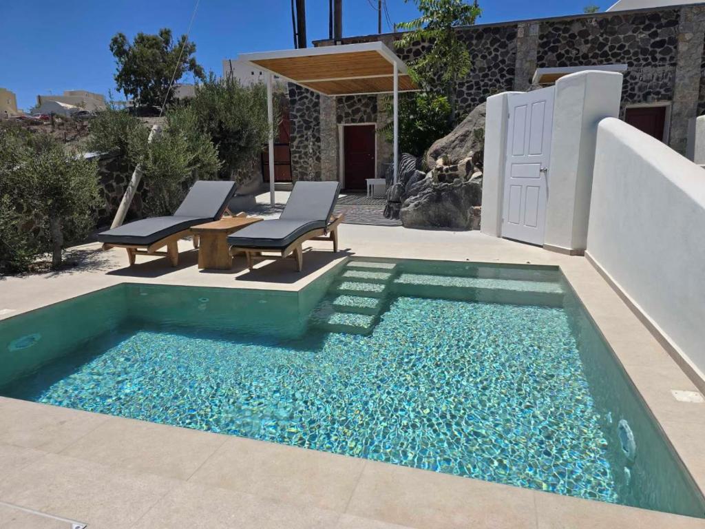 a small pool with blue water in a patio at Splendour Hotel and Suites in Firostefani