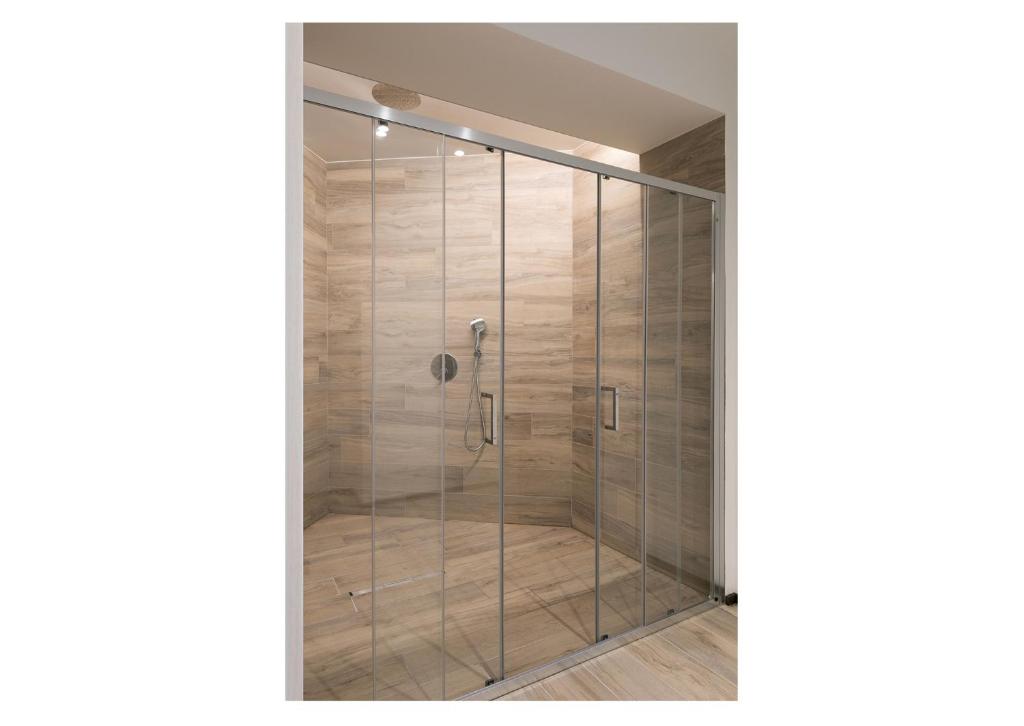 a shower with a glass door in a room at Villa Serena in Finale Ligure