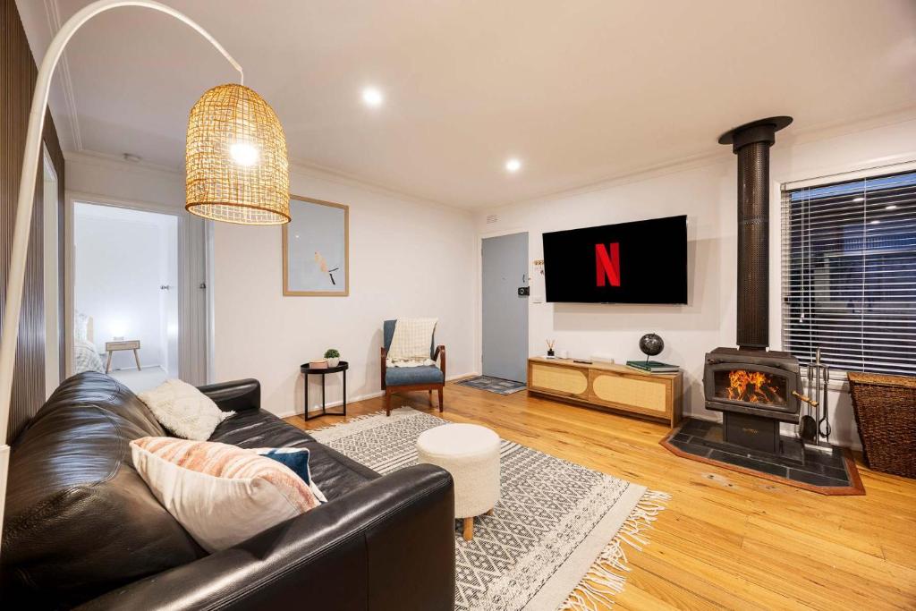 a living room with a couch and a fireplace at The Eighth - Pet Friendly in Rosebud