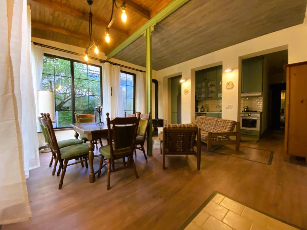a dining room with a table and chairs at Wonderwood Borjomi Provencal in Borjomi