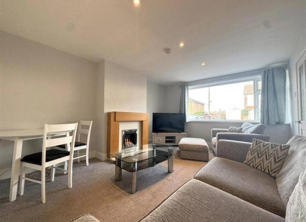 a living room with a couch and a table at 3bed house Brighouse - working professionals welcome FREE parking & WI-FI in Brighouse
