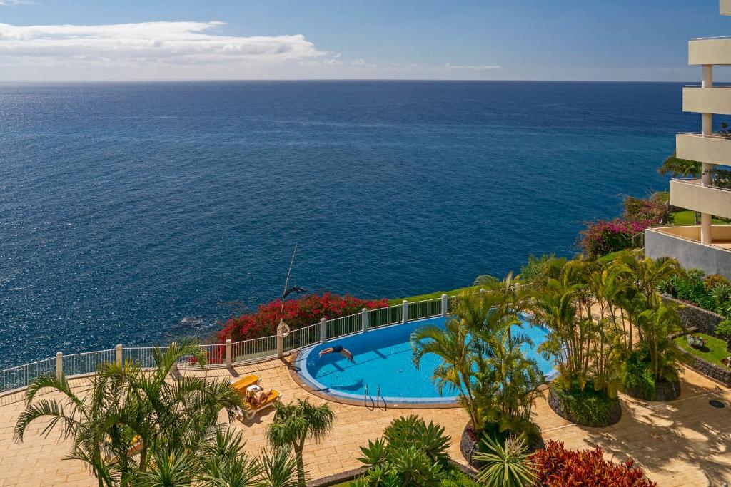 a view of a swimming pool and the ocean at Arcadas III by An Island Apart in Funchal